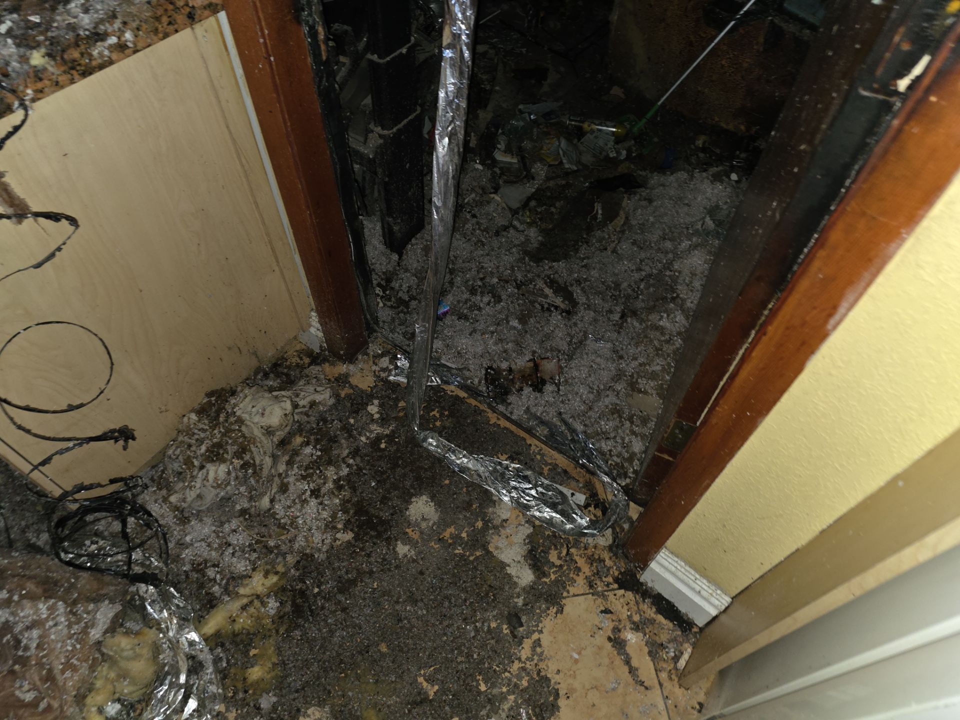 Fire debris and ash covering floor after structural fire